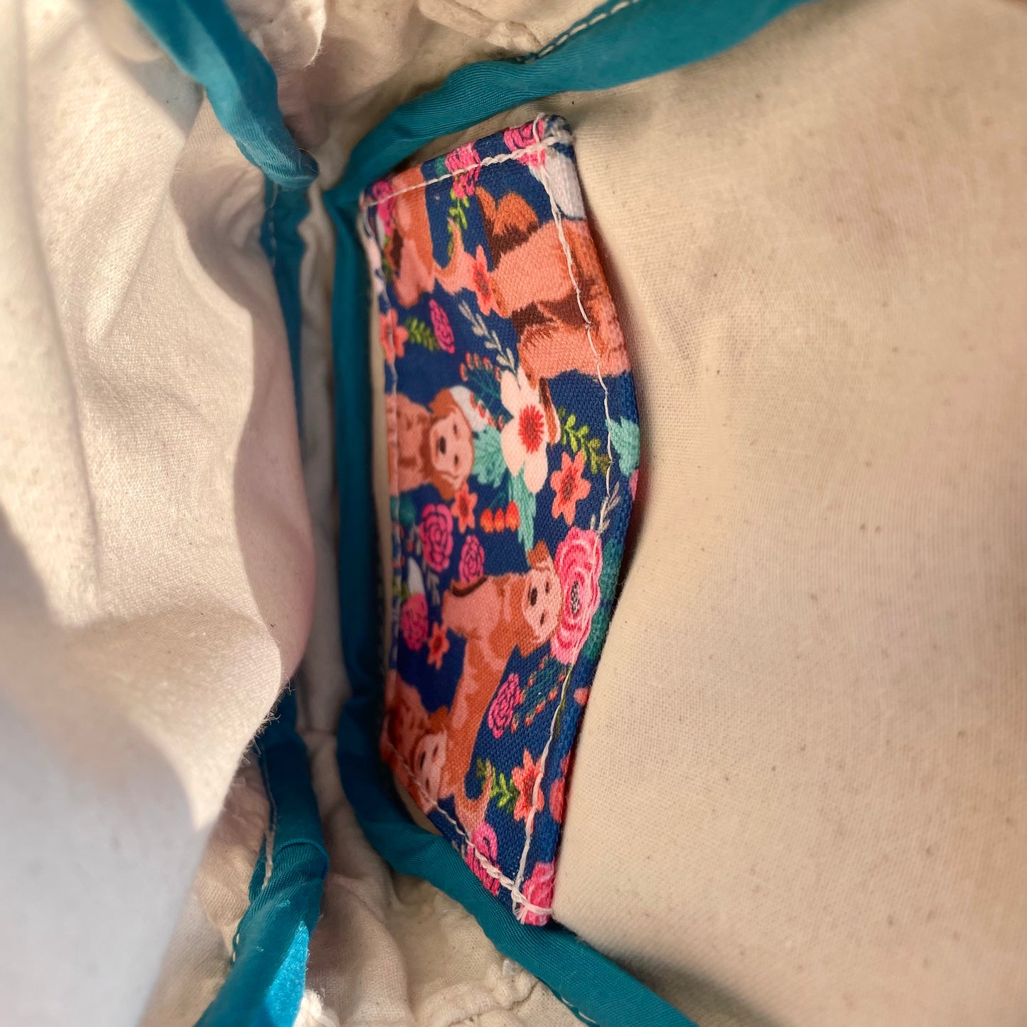 Sac de corps en liège brun pâle au devant en canevas rose à motifs de chiens.