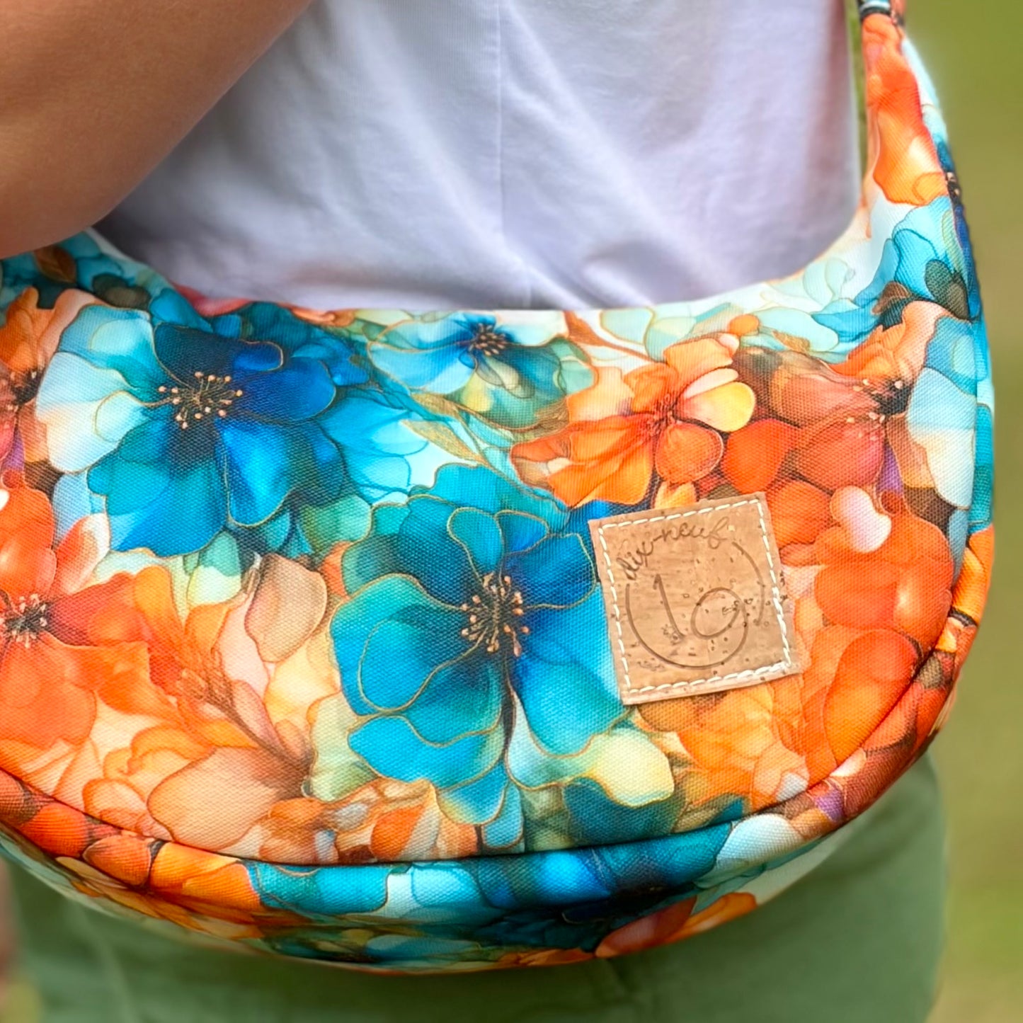 Le Charlevoix - Sac en demi-lune en canevas à motif de fleurs bleues et oranges